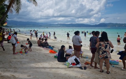<p><strong>INFLUX OF TOURISTS.</strong> Tourists enjoy the white sand beach of Boracay Island on Good Friday (April 15, 2022). During the Holy Week, Boracay Island has recorded 44,981 tourist arrivals -- the highest was on Maundy Thursday with 12,266 guests.<em> (PNA photo courtesy of Jun Aguirre)</em></p>