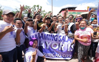 <p><strong>CAMPAIGN.</strong> Aksyon Demokratiko standard bearer Francisco "Isko Moreno" Domagoso (front row, with eyeglasses) mingles with supporters during his visit to Surigao City, Surigao del Norte on Monday (April 18, 2022). Domagoso said he will initiate resilient mass-housing projects to protect vulnerable people in typhoon-prone areas.<em> (Photo courtesy of IM Media)</em></p>