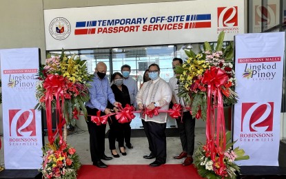 <p><strong>OFF-SITE PASSPORT SERVICES</strong>. Department of Foreign Affairs (DFA) Assistant Secretary Senen Mangalile (in white barong) leads the launching ceremony for the temporary off-site passport services (TOPs) at Robinsons Starmills in the City of San Fernando, Pampanga on Wednesday (April 20, 2022). The opening of TOPs is aimed at easing the backlog of consular offices in the renewal of passports for tourists and overseas Filipino workers.<em> (Photo by Marna del Rosario)</em></p>
