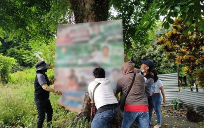 <p><strong>TAKEN DOWN</strong>. Environment office personnel, backed by police, remove political posters, and campaign materials illegally nailed and tacked on trees in Soccsksargen as part of the “Oplan Baklas” campaign to spare the trees from destruction on Wednesday (April 20, 2022). More than 7,000 campaign materials posted on trees were taken down as a result of the drive. <em>(Photo courtesy of DENR-12)</em></p>