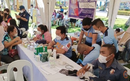 <p><strong>CARAVAN OF SERVICES</strong>. The Department of Health Western Visayas Center for Health Development provides free medical services during the Duterte Legacy Caravan hosted by the Philippine National Police at Camp Martin Delgado regional headquarters in Iloilo on Thursday (April 21, 2022). The one-day event was participated in by more or less 30 government agencies and served around 1,000 people. <em>(PNA photo by PGLena)</em></p>