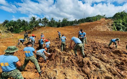 <p><strong>SEARCH.</strong> Policemen digging out debris to find landslide victims in Baybay City in this April 20, 2022 photo. The Philippine National Police sent on Thursday (April 21, 2022) its third batch of search, rescue and retrieval (SRR) personnel to villages in Baybay City and Abuyog, Leyte. <em>(Photo courtesy of PNP Eastern Visayas)</em></p>