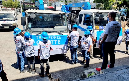 <p><strong>OFF TO BOHOL</strong>. Some of the 10 linemen of Rosch, a private contractor of Visayan Electric, mount a tarpaulin in front of the boom truck that they will bring to Buenavista and Getafe towns in Bohol that remain without light four months after the Typhoon Odette. Visayan Electric president and chief operating officer Raul Lucero on Friday (April 22, 2022) said sending the augmentation crew to help restore power in Bohol is a way to pay forward after the firm's franchise area's electric connection has been reconnected due to the help of other distribution utilities from Luzon and Mindanao.<em> (Photo courtesy of Visayan Electric)</em></p>