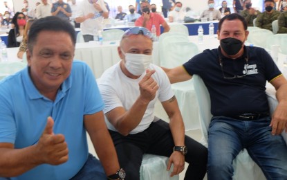 <p><strong>PEACE PACT</strong>. Reelectionists Negros Oriental Gov. Roel Degamo and House Rep. Arnolfo Teves Jr., and lawyer George Arnaiz, who is seeking the 2nd district congressional seat, pose for a photo opportunity at the sidelines of a peace covenant signing in Sibulan town. Provincial and church officials expressed elation over the presence of Degamo and Teves, who were known to be at odds perennially, during the event held on Monday (April 25, 2022). (<em>PNA photo by Judy Flores Partlow)</em></p>