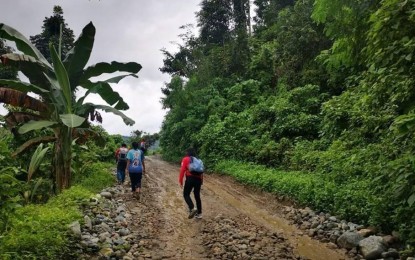 <p>Volunteers of the Philippine Red Cross in Iligan often walk through muddy, unpaved roads to reach villages such as Barangay Lanipao, a 45-minute drive from Iligan City, Lanao del Norte. While the volunteers use vans to get around, some areas are impassable for four-wheel vehicles. (<em>PRC/Iligan)</em></p>
<p> </p>
<p> </p>