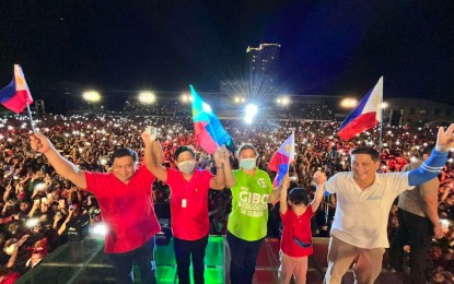 <p>UniTeam presidential candidate Bongbong Marcos (2nd from left) and vice-presidential aspirant Sara Duterte (in green shirt) are joined by Senatorial bets Jinggoy Estrada (left) and Migs Zubiri (right) on stage during a rally at the Pelaez Sports Complex, Cagayan de Oro City on Tuesday (April 26, 2022). (<em>Contributed photo</em>)</p>
<p> </p>
<p> </p>