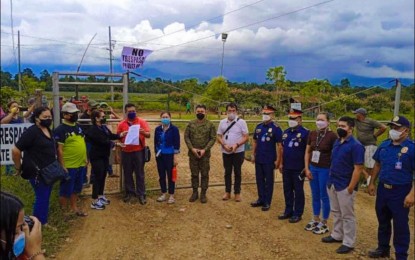<p><strong>SERVED.</strong> Officials of the National Commission on Indigenous Peoples Region 10, other government agencies, police, and military serve a cease and desist order on Kianteg Development Corporation in Quezon, Bukidnon on Saturday (April 30, 2022). The company and all other claimants are ordered to stay out of the property being claimed by the Manobo-Pulangihon Indigenous tribe as its ancestral land. <em>(Photo courtesy of NCIP)</em></p>