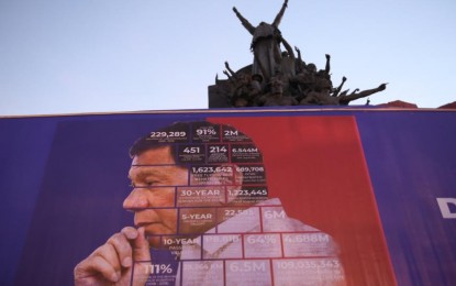 <p><strong>LEGACY.</strong> President Rodrigo Duterte’s photo serves as background of his administration’s accomplishment in numbers during the “Duterte Legacy Caravan” at People Power Monument in Edsa, Quezon City on Labor Day Sunday (May 1, 2022). The event is a convergence of various government agencies to bring services closer to the people. <em>(PNA photo by Avito Dalan)</em></p>