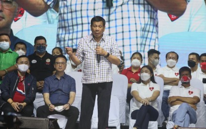 <div class="caption">
<p><strong>PEP TALK. </strong>President Rodrigo Duterte addresses the crowd at a campaign rally at Arca South in Taguig City on Sunday night (May 1, 2022). Among the candidates he endorsed were senatorial bets Alan Peter Cayetano (seated, 2nd from left) and former presidential spokesperson Harry Roque (standing, left). <em>(PNA photo by Avito Dalan)</em></p>
</div>