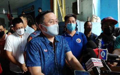 <p><strong>SITE VISIT.</strong> Sen. Christopher “Bong” Go talks to the media during his visit to fire victims in Barangay Pineda, Pasig City on Tuesday (May 3, 2022). He distributed financial assistance, grocery items, bicycles, computer tablets, vitamins, and pairs of shoes to 109 families temporarily staying at a covered court.<em> (PNA photo by Wilnard Bacelonia)</em></p>