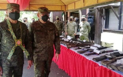 <p><strong>FIGHTING INSURGENCY</strong>. Philippine Army chief Lt. Gen. Romeo Brawner Jr. (left) and Army 8th Infantry Division commander Maj. Gen. Edgardo de Leon check firearms recently seized in Leyte and Samar provinces during a display at the Army headquarters in Catbalogan City, Samar on Tuesday (May 3, 2022). Brawner said the gains in the fight against insurgency are the results of the "whole-of-nation" approach. <em>(PNA photo by Sarwell Meniano)</em></p>
