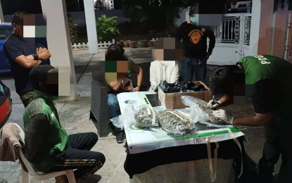 <p><strong>END OF THE LINE</strong>. A Nigerian national (seated, left) looks on as authorities conduct an inventory of the P1.9 million worth of high-grade marijuana or kush that was seized from him during a controlled delivery operation in Angeles City on Thursday (May 5, 2022). The package containing illegal drugs came from Greenwich, Connecticut, USA.<em> (Photo courtesy of PDEA-Central Luzon)</em></p>
