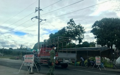 <p><strong>CHECKPOINT</strong>. A police officer mans a checkpoint at the intersection in Barangay Buyon, Bacarra, Ilocos Norte in this undated photo. The Philippine National Police said it is implementing two types of police intervention - a regular checkpoint and Óplan Sita' - to ensure peaceful and orderly 2022 elections. <em>(File photo by Leilanie G. Adriano)</em></p>