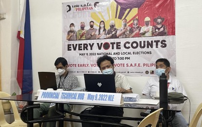 <p><strong>CHECK.</strong> A three-man technical hub composed of personnel from the Department of Science and Technology and Department of Information and Communications Technology are on standby during the final testing and sealing of vote-counting machines in Laoag City, Ilocos Norte on Friday (May 6, 2022). The machines will only be opened again on election day Monday (May 9). <em>(PNA photo by Leilanie G. Adriano)</em></p>
