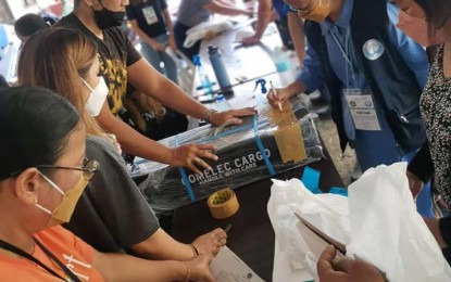 <p><strong>ELECTION PARAPHERNALIA.</strong> Members of the electoral board and representatives of the Parish Pastoral Council for Responsible Voting inspect election paraphernalia during their distribution in Zamboanga City on Saturday (May 7, 2022). The city’s two districts have 98 villages and more than 403,000 registered voters.<em> (Photo courtesy of City Hall-PIO)</em></p>