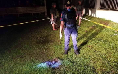 <p><strong>BLAST SITE.</strong> A police officer points to a spot where a 40mm projectile landed and exploded on the municipal grounds of Datu Unsay, Maguindanao Sunday night (May 8, 2022). Two other projectiles were fired in the same spot and two more in nearby Shariff Aguak town minutes later. <em>(Photo courtesy of Maguindanao PPO)</em></p>