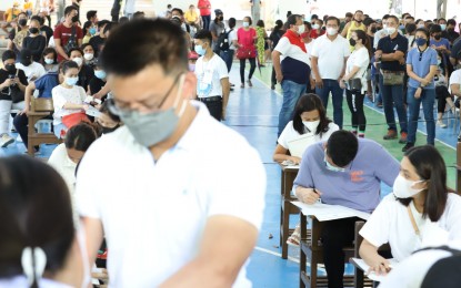 <p><strong>BIG DAY.</strong> Voters fill up their ballots at the Christ the King Seminary covered court along E. Rodriguez Avenue, Quezon City, which was converted into a voting center for the national and local elections on Monday (May 9, 2022). Among those seen at the site were re-electionist Mayor Joy Belmonte; her husband, Raymond Alimurung; and her father, former Speaker of the House of Representatives and QC mayor Sonny Belmonte. <em>(PNA photo by Robert Oswald P. Alfiler)</em></p>