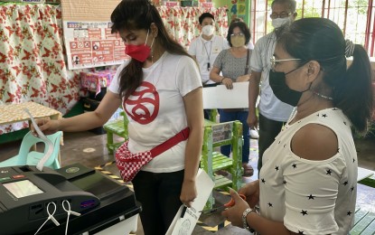 <p><strong>SET ASIDE DIFFERENCES</strong>. Senator Ma. Imelda Josefa "Imee" Marcos checks the printed copy of her vote receipt at the Cabeza Elementary School in Laoag City, Ilocos Norte on Monday (May 9, 2022). Marcos urged Filipinos to set aside political differences once the elections conclude. <em>(Photo by Leilanie G. Adriano)</em></p>