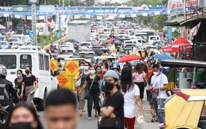 <p><strong>BUSY DAY.</strong> Batasan Road in Quezon City turns into a parking lot while voters troop to the President Corazon Aquino elementary School and Batasan Hills National High School on Monday (May 9, 2022). Traffic enforcers and police manned the major street since voting began at 6 a.m. <em>(PNA photo by Robert Oswald P. Alfiler)</em></p>