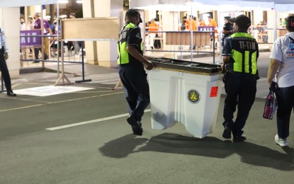 <p><strong>RESPECT POLLS RESULTS</strong>. The Department of Public Order and Safety personnel carry the ballot boxes during their arrival at the Quezon City Hall compound on Monday night (May 9, 2022). The National Task Force to End Local Communist Armed Conflict (NTF-ELCAC) on Tuesday urged the public to “respect” the will of the Filipino people after various groups trooped to the Commission on Elections in Intramuros, Manila to protest alleged widespread electoral fraud in the May 9 polls. <em>(PNA photo by Robert Oswald P. Alfiler)</em></p>