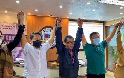 <p><strong>MILF-BACKED WINNERS.</strong> Lawyer Mustapha Nasroding (center), the  Cotabato City acting election officer and city board of canvassers chairperson, proclaims Tuesday night (May 10, 2022) mayor-elect Bruce Matabalao (in green shirt) and vice mayor-elect Butch Abu (in white) as winners in the May 9 polls. Both elected officials ran under the United Bangsamoro Justice Party, the political arm of the Moro Islamic Liberation Front. <em>(Photo lifted from Bruce Matabalao Facebook Page)</em></p>