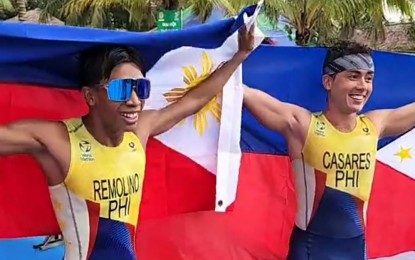 <p><strong>ONE-TWO.</strong> Andrew Kim Remolino (left) and Fernando Tan Casares clinch the silver and gold medals, respectively, in the triathlon event of the 31st Southeast Asian Games in Tuan Chau, Vietnam on Saturday (May 14, 2022). Like Casares, women’s event bet Kim Mangrobang retained her crown. <em>(Photo courtesy of PSC-POC)</em></p>