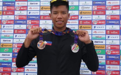 <p><strong>BEMEDALLED ATHLETE.</strong> Army Private Chris Nievarez shows the silver and bronze medals he won in two rowing categories of the 31st Southeast Asian Games in Hanoi, Vietnam. A total of 21 Army athletes are part of the Team Philippines that is competing in the games. <em>(Photo courtesy of the Philippine Army)</em></p>