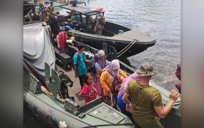 <p><strong>ALL SAFE.</strong> Marine troops rescue 13 people from a small boat that catches fire Sunday (May 15, 2022) while traveling from Sapa-Sapa town to Bongao, the capital of Tawi-Tawi. All passengers were found to be in good physical condition and turned over to their relatives in Bongao town. <em>(Photo courtesy of JTF Tawi-Tawi)</em></p>