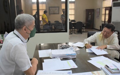 <p><strong>NEW LAWMAKER</strong>. Negros Occidental fifth district congressman-elect Emilio Bernardino Yulo (right) signs his oath of office after he was sworn in by Governor Eugenio Jose Lacson at the Provincial Capitol in Bacolod City on Monday (May 16, 2022). Yulo has committed to support the initiative to revive the Negros Island Region in Congress. <em>(Photo courtesy of PIO Negros Occidental)</em></p>