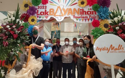 <p><strong>TOURISM FAIR</strong>. Negros Occidental Governor Eugenio Jose Lacson (left) and Department of Tourism-Western Visayas Regional Director Cristine Mansinares (right) lead the opening of the Lakbayanihan Tourism Fair 2022 at Ayala Malls Capitol Central in Bacolod City on Monday (May 16, 2022). The province’s first tourism fair in two years, the event, which runs until May 29, promotes tourism attractions across the province's 32 city and municipal governments, including the capital city of Bacolod, in a bid to revive the local tourism industry. <em>(PNA photo by Nanette Guadalquiver)</em></p>