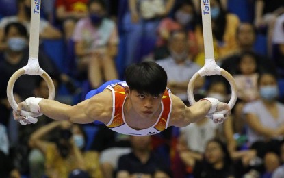 <p><strong>THREE GOLDS</strong>. Reigning world champion Carlos Yulo shows his impressive winning routine in the men’s ring exercise in the 31st Vietnam Southeast Asian Games in Hanoi, Vietnam on Sunday (May 15, 2022). After winning the all-around on Friday, Yulo also triumphed in the floor exercise to lead an eight-gold medal haul on Sunday as the Philippines jostled with Thailand for second overall behind host Vietnam.<em> (Photo courtesy of Team Philippines)</em></p>