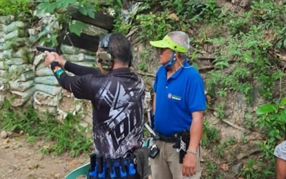 <p><strong>FIREARMS LAW</strong>. Philippine Shooters and Match Officers Confederation (PSMOC) national coordinator for shooters development Lito Ladroma (right in blue shirt) conducting basic pistol marksmanship at the Front Sight Gun Club in Tubod, Minglanilla, Cebu in this undated photo. Ladroma said responsible gun owners and sports shooters are thankful to President Rodrigo Duterte for signing Republic Act (RA) 11766 amending RA 10591 extending the validity of license to carry and registration of firearms for up to 10 years, saying it will encourage up-to-date documentation of guns.<em> (Contributed photo)</em></p>