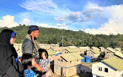 <p><strong>NEW HOUSES.</strong> A family displaced by the 2017 Marawi siege in their new community at Marawi Resettlement Site Phase 1: Hadiya Village, Barangay Dulay West. A total of 109 permanent houses constructed by the UN Habitat were inaugurated in the area last February 2021.<em> (Photo courtesy of UN-Habitat)</em> </p>