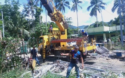 <p><strong>POWER DOWN</strong>. Linemen from Leyte help repair facilities damaged by Typhoon Odette in Bontoc, Southern Leyte in this May 18, 2022 photo. The Southern Leyte Electric Cooperative (Soleco) is eyeing to restore power by next month to the remaining 71 villages badly hit by the destructive typhoon five months ago. <em>(Photo courtesy of Soleco)</em></p>