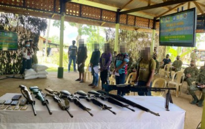<p><strong>TIRED FIGHTERS.</strong> Five communist rebels operating in the mountains of Lebak, Sultan Kudarat, pledge allegiance to the Philippine flag after their surrender Wednesday (May 18, 2022) in Upi, Maguindanao. The group also turned in eight high-powered firearms during their surrender. <em>(Photo courtesy of 57IB)</em></p>