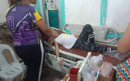<p><strong>FOOD POISONING?</strong> An elementary school pupil receives treatment in a medical facility after exhibiting symptoms of possible food poisoning such as vomiting and stomach pain. The Provincial Health Office in Negros Oriental reported that more than 70 grade school pupils in Sta. Catalina town came down with gastroenteritis secondary to suspected food poisoning after having consumed fresh milk at a feeding program on Thursday (May 19, 2022).<em> (Photo courtesy of the Negros Oriental Provincial Police Office)</em></p>