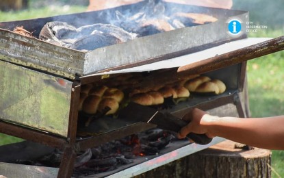 <p><strong>NATIVE BREAD</strong>. “Salbaro” being baked on an open-top oven fired by coconut husks during a cooking demonstration on May 13, 2022 in San Carlos City, Negros Occidental. The coconut-filled bread has been recognized by the northern Negros city as a heritage delicacy in observance of the National Heritage Month this May. <em>(Photo courtesy of NegOcc-San Carlos City Information Office)</em></p>