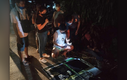 <p><strong>BUSTED.</strong> Pautao Barangay Councilor Alter Dusaran (sitting right with red cap) of Bacuag town, Surigao del Norte, is arrested by PDEA-13 agents in a buy-bust in his village Thursday night (May 19, 2022). Dusaran is classified by authorities as a high-value target.<em> (Photo courtesy of PDEA-13)</em></p>