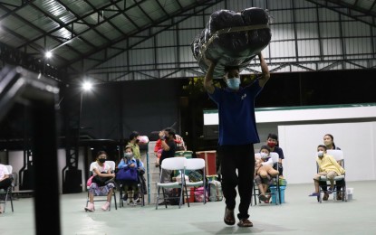 <p><strong>WAY BACK HOME.</strong> Beneficiary families of the "Balik Probinsya, Bagong Pag-Asa" program get ready for departure from the BP2 depot in Quezon City on May 5, 2022. Three families composed of 13 individuals traveled back to Samar and Northern Samar provinces on that day. <em>(PNA photo by Robert Oswald P. Alfiler)</em></p>