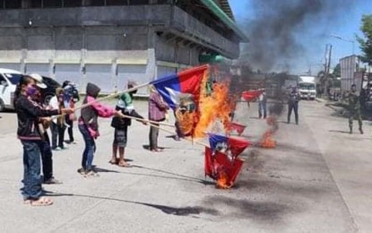 <p><strong>EMPTY PROMISES</strong>. Eleven New People's Army (NPA) rebels surrender on Friday (May 20, 2022) in Pigcawayan, North Cotabato due to empty promises of the terrorist organization. The surrenderers denounced, torched NPA flags and pledged allegiance to the Philippine flag.<em> (Photo courtesy of the Army's 602nd Infantry Brigade)</em></p>