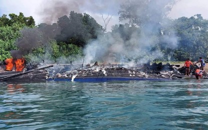 <p><strong>SHIP FIRE.</strong> The remains of MV Mercraft 2 off the coast of Baluti Island in Barangay Cawayan, Real, Quezon. Malacañang on Tuesday (May 24, 2022) offered sympathies to the families of the victims.<em> (Photo courtesy of PCG)</em></p>