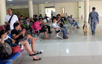 <p><strong>SEAFARERS</strong>. Travelers await boarding calls at the passenger terminal at the Dumaguete City port in this undated photo. The Philippine Ports Authority and the Maritime Industry Authority in the Negros Oriental capital are investigating alleged fixers selling boat tickets at a higher price following complaints that have surfaced recently. <em>(PNA file photo by JFP)</em></p>