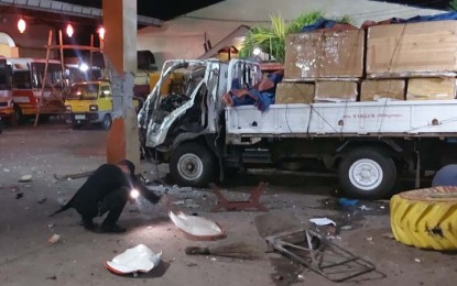 <p><strong>TWIN BLASTS.</strong> An ordnance explosive demolition personnel sifts through the explosion site at the bus station of D'Biel Transport Company on Valderosa Street, Barangay La Piedad, Isabela City, Basilan. The two explosions happened one after the other Monday (May 30, 2022). <em>(Photo lifted from the Facebook page of Ronda del Basilan)</em></p>