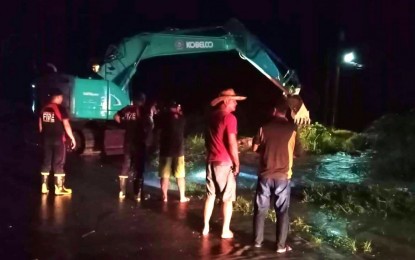 <p><strong>ROAD CLEARING.</strong> Personnel from the  Bureau of Fire Protection in Tantangan, South Cotabato, assist in the clearing of a flooded portion of the national highway in Barangay Bukay Pait on Sunday night (May 29, 2022). Low-lying communities in the area experienced severe flooding following heavy rains. <em>(Photo courtesy of BFP-Tantangan)</em></p>
