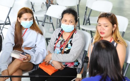 <p><strong>COUNTING ON THE GOV’T.</strong> The members of the Taganile family talk to the Philippine News Agency prior to their departure for Agusan del Sur under the “Balik Probinsya, Bagong Pag-asa” program on Tuesday (May 31, 2022). (From left) Lilibeth, 21; Leonila, 61; and Leah May, 23, shared their hardships and hope for a better life in the province. <em>(PNA photo by Robert Oswald Alfiler)</em></p>