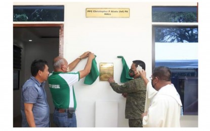 <p><strong>IN MEMORY OF A SOLDIER</strong>. Lt. Col. J-jay Javines (2nd from right), commanding officer of the Army’s 79th Infantry Battalion, unveils the marker of the Alada Hall together with Escalante City Vice Mayor Rogelio Prietos (2nd from left) and executive assistant Aladdin Lumayno while Rev. Fr. Aurelius Pepino of St. Roch Parish Church blesses the building on May 29, 2022. The structure is dedicated to the memory of Pfc. Christopher Alada, who died during an encounter with CPP-NPA rebels in Barangay Kapitan Ramon, Silay City on August 20, 2021. <em>(Photo courtesy of 79th Infantry Battalion, Philippine Army)</em><br /><br /></p>
