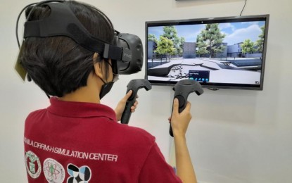 <p><strong>VIRTUAL SIMULATION</strong>. A staff of the University of the Philippines Manila (UPM) Disaster Risk Reduction and Management in Health (DRRM-H) Center shows how virtual simulation is used in training for disasters. The establishment of the center was funded by the Department of Science and Technology for over PHP69.4 million. <em>(Photo courtesy of DOST)</em></p>