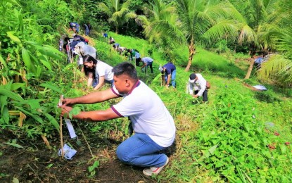 <p><strong>'TREE CARING'.</strong> Personnel and partners of the Department of Environment and Natural Resources in the Soccsksargen region plant trees in celebration of Philippine  Environment Month on Wednesday (June 8, 2022). At least 41,000 tree seedlings were planted by volunteers in the Soccsksargen area and the Bangsamoro Autonomous Region in Muslim Mindanao. <em>(Photo courtesy of DENR-12)</em></p>