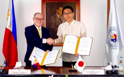 <p><strong>GRANT DEAL.</strong> Foreign Affairs Secretary Teodoro Locsin Jr. (left) and Japanese Ambassador Koshikawa Kazuhiko seal their exchange of diplomatic notes with a handshake at the Department of Foreign Affairs office in Pasay City on Thursday (June 9, 2022). Japan will provide a JPY710 million (approximately PHP289.6 million) grant aid to the Bangsamoro Autonomous Region in Muslim Mindanao and the Philippine Coast Guard.<em> (DFA photo by Philip Fernandez)</em></p>