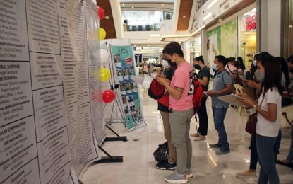 <p><strong>EMPLOYMENT OPPORTUNITIES.</strong> Job applicants scour the list of vacancies during the jobs fair at Robinsons Place in Butuan City. Some 1,189 applicants from different provinces in the Caraga Region join the separate job fairs by the Department of Labor and Employment in Caraga at the Robinsons Place in Butuan City and Prosperidad, Agusan del Sur, Sunday (June 12, 2022).<em> (Photo courtesy of DOLE-13)</em></p>
